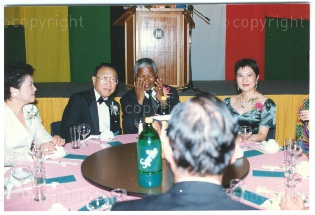 Parktonian Hotel, Johannesburg, Transvaal, South Africa, 19940309. PHOTO: ANC Archives.

The President of the African National Congress (ANC), Nelson Mandela, enjoys some humour with his fellow guests at an ANC voter education fund-raising dinner hosted by the Taiwanese community in South Africa on the 9 March 1994. Leading up to the 1994 elections in South Africa, Taiwan embarked on a public relations campaign in efforts to improve relations with the ANC, providing financial support to the ANC's election campaign. South Africa's diplomatic ties with Taiwan (The Republic of China) ended in 1998 however when Nelson Mandela, as President of South Africa, recognized the People's Republic of China.