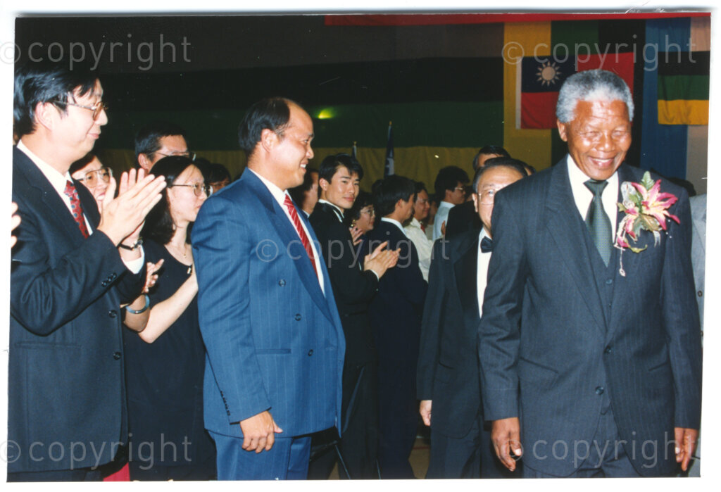 Parktonian Hotel, Johannesburg, Transvaal, South Africa, 19940309. PHOTO: ANC Archives.

The President of the African National Congress (ANC), Nelson Mandela (right), is applauded by assembled guests at an ANC voter education fund-raising dinner hosted by the Taiwanese community in South Africa on the 9 March 1994. Leading up to the 1994 elections in South Africa, Taiwan embarked on a public relations campaign in efforts to improve relations with the ANC, providing financial support to the ANC's election campaign. South Africa's diplomatic ties with Taiwan (The Republic of China) ended in 1998 however when Nelson Mandela, as President of South Africa, recognized the People's Republic of China.