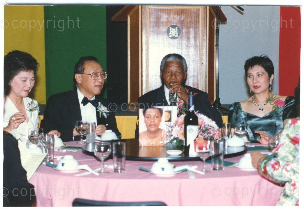 Parktonian Hotel, Johannesburg, Transvaal, South Africa, 19940309. PHOTO: ANC Archives.

The President of the African National Congress (ANC), Nelson Mandela (centre), is seated at a table with other dignitaries at an ANC voter education fund-raising dinner hosted by the Taiwanese community in South Africa on the 9 March 1994. Leading up to the 1994 elections in South Africa, Taiwan embarked on a public relations campaign in efforts to improve relations with the ANC, providing financial support to the ANC's election campaign. South Africa's diplomatic ties with Taiwan (The Republic of China) ended in 1998 however when Nelson Mandela, as President of South Africa, recognized the People's Republic of China.
