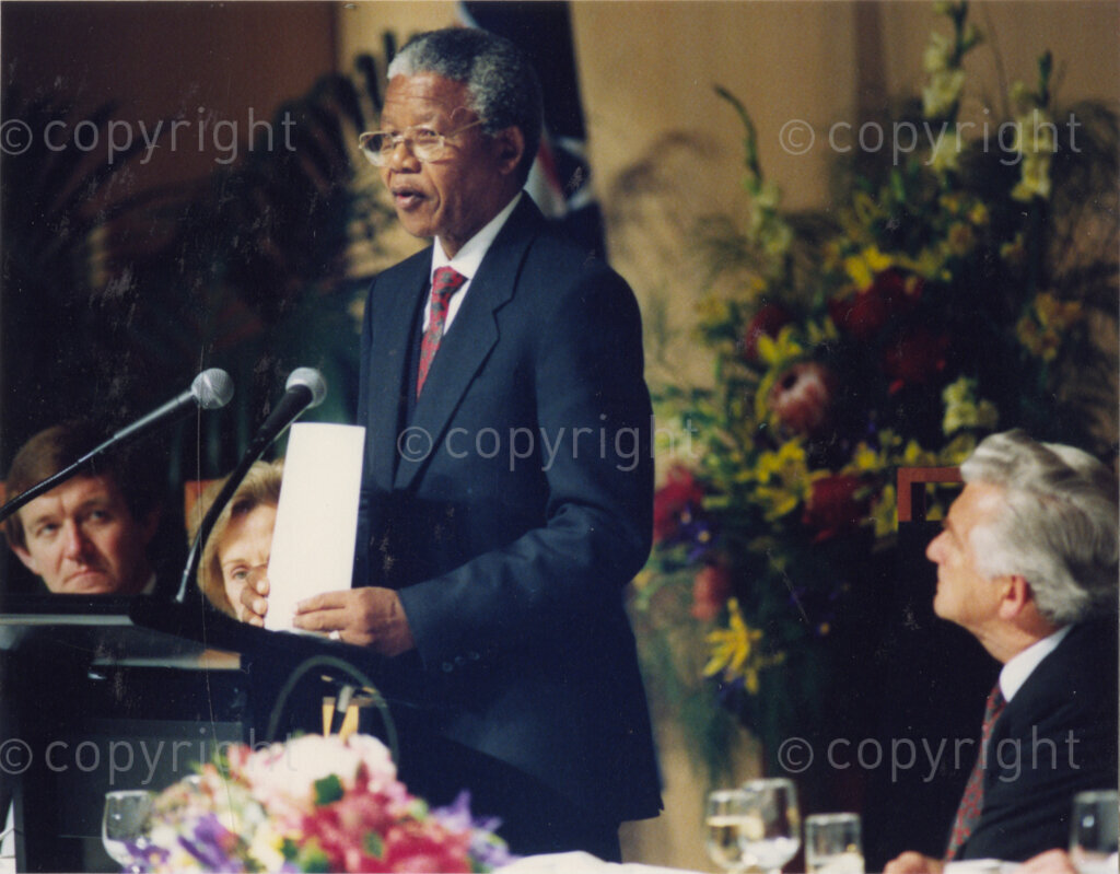 Australia, October 1990. PHOTO: ANC Archives: Whenever he addresses the assembled people, the crowds are inspired by the commitment and resilience of the iconic Nelson Mandela. However, during this 1990 visit to Australia, Mandela is criticised by those who are angered by his neglect to mention the plight of the Aborigines. Here, Mandela is flanked by Prime Minister, Bob Hawke on the right. Monday 22 October to Saturday 27 October 1990.