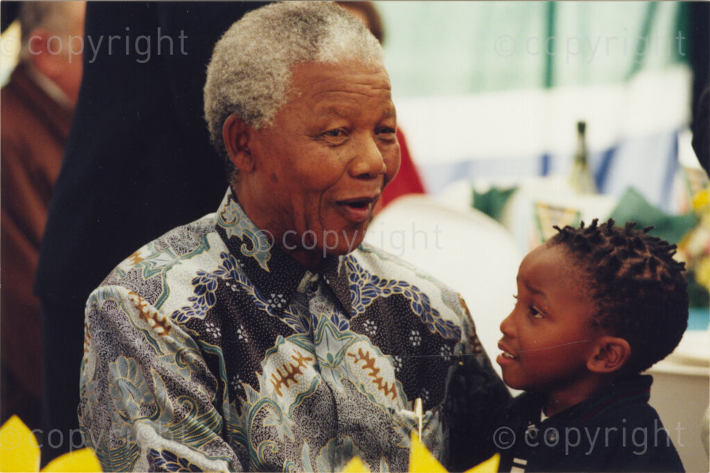 Johannesburg, Gauteng, South Africa, 19960719. PHOTO: Pan African Archives.

President Nelson Mandela shares a special moment with a small child at his 78th birthday party in July 1996. African National Veterans are actually the invited guests at this year's event. They each receive a card from Mandela, thanking them for their dedication to the ANC and to its liberation struggle.