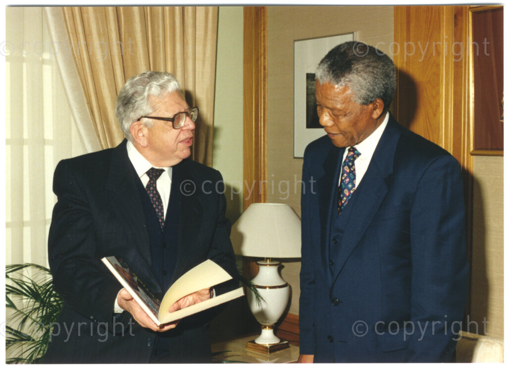 South Africa, 19940805. PHOTO: ANC Archives.

The chairman of the Press Corporation of South Africa (Perskor), JM (Koos) Buitendag (left) awards President Nelson Mandela of South Africa (right) with a memento to mark a donation of R50 000 made by the Bona People's Fund towards the Nelson Mandela Children's Fund, location unknown, 5 August 1994.