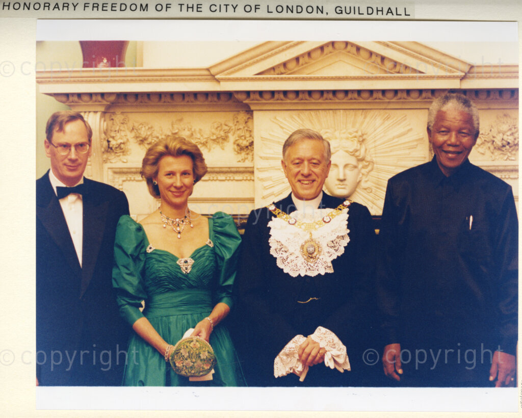 Guildhall Great Hall, London, United Kingdom, 19960701. PHOTO: ANC Archives: President Nelson Mandela makes a state visit to the United Kingdom, in July 1996. At the Guildhall Great Hall in London, Mandela is presented with the honorary Freedom of the City of London. He is seen at this venue, (on the right), standing beside a gentleman who is presumed to be the Lord Mayor of London, who is wearing a mayoral gold chain. The other two dignitaries are unknown.