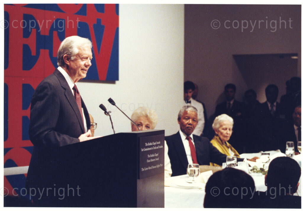 Rothko Chapel, Houston, Texas, United States of America, 19911208. PHOTO: ANC Archives.

Former President of the United States of America (USA), Jimmy Carter (standing), Nelson Mandela (second right) and Dominique de Menil (first right) at the twentieth anniversary of the Rothko Chapel awards in Houston, Texas, USA , when Nelson Mandela was keynote speaker and recipient of the special Carter-Menil Human Rights Prize. The award was presented to Mandela by Carter and De Menil.