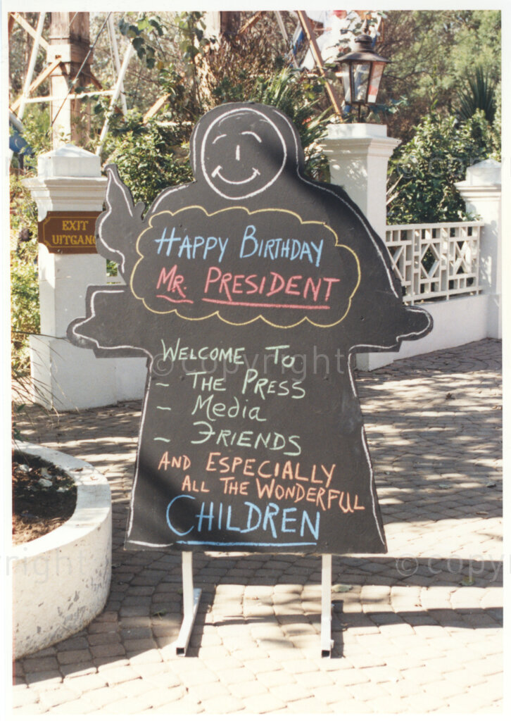 Gold Reef City, Johannesburg, Gauteng, South Africa, 19950717. PHOTO: ANC Archives.

A chalkboard welcomes the President of South Africa, Nelson Mandela, the media and press, friends and 'especially the children' to the 77th birthday celebration of Nelson Mandela at Gold Reef City, Johannesburg, on Monday the 17th July 1995. More than 2,000 underprivileged children, including 34 children who are currently imprisoned, street children, children from orphanages, mentally disabled children and children who have been abused, have been invited to attend his birthday celebration with him. Nelson Mandela is attending this function in his personal capacity as he places special emphasis on the plight of children.