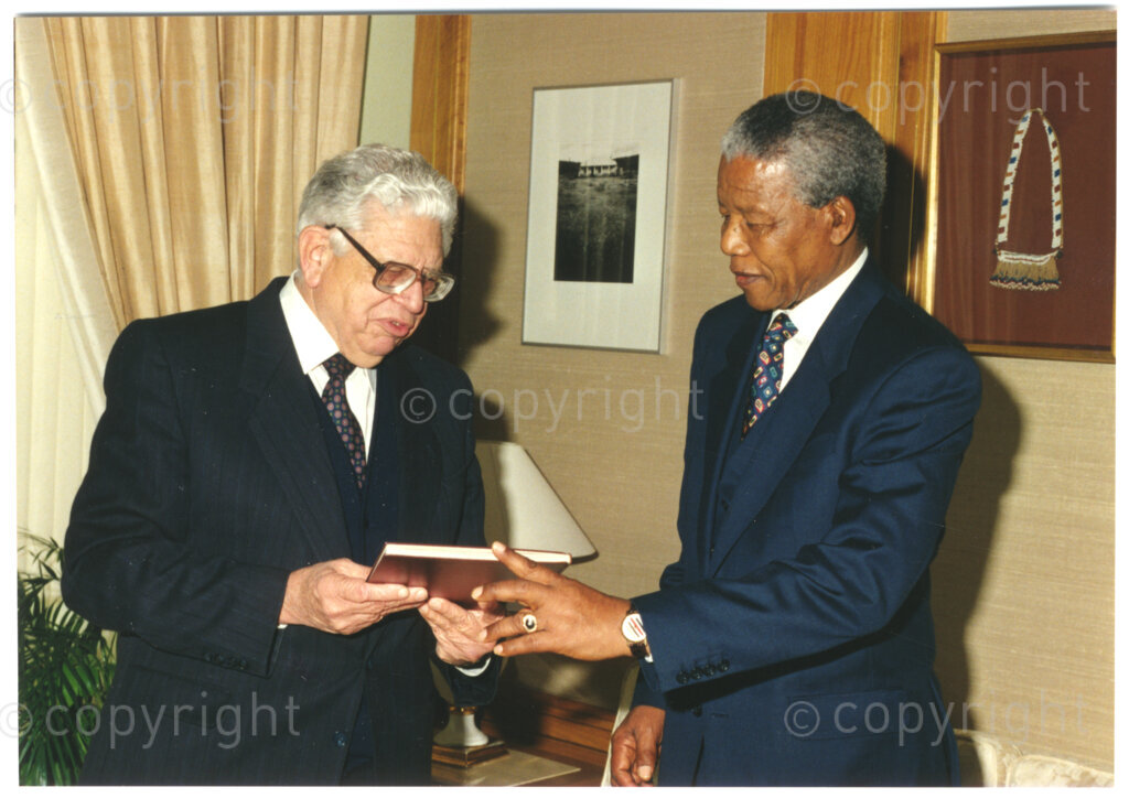 South Africa, 19940805. PHOTO: ANC Archives.

The chairman of the Press Corporation of South Africa (Perskor), JM (Koos) Buitendag (left), awards President Nelson Mandela of South Africa (right) with a memento to mark a donation of R50 000 made by the Bona People's Fund towards the Nelson Mandela Children's Fund on 5 August 1994.
