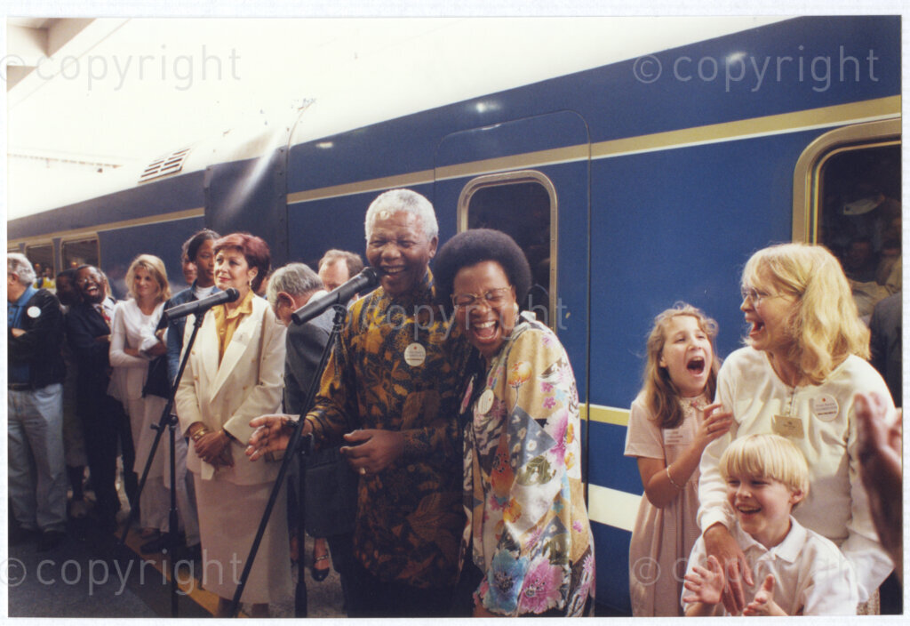 Cape Town Railway Station, Cape Town, Cape Province, Republic of South Africa, 19970927. PHOTO: ANC Archives.

The launch journey of the new Blue Train in September 1997. President Nelson Mandela, GraÃ§a Machel and one of their celebrity guests, Mia Farrow share a joke on a platform at Cape Town Railway Station, Cape Province, South Africa on 27 September 1997.