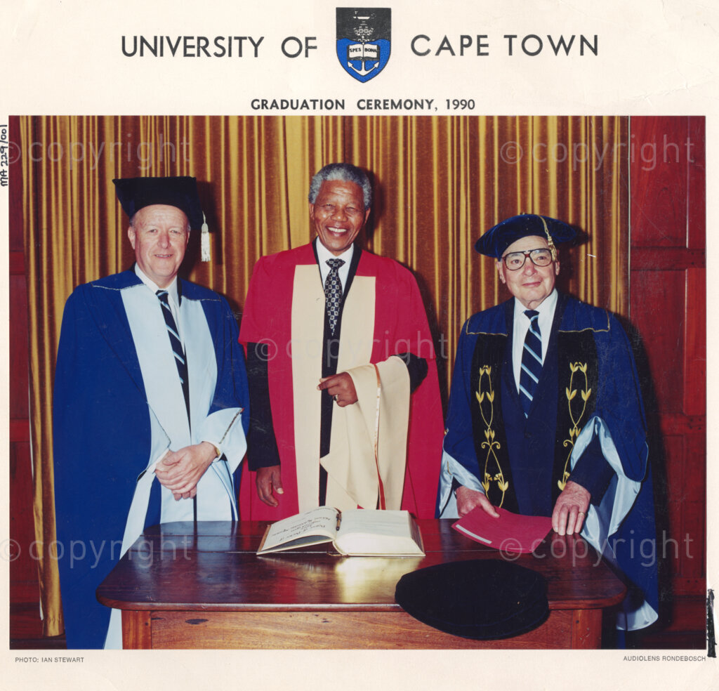 University of Cape Town, Cape Town, Cape Province, Republic of South Africa, 19901130. PHOTO: ANC Archives.

Nelson Mandela, the deputy president of the African National Congress (ANC), stands between University of Cape Town Vice Chancellor Stuart Saunders (left) and Chancellor Harry Oppenheimer (right) before he is awarded an honorary doctorate in law by the University of Cape Town, the Republic of South Africa, 30 November 1990.
