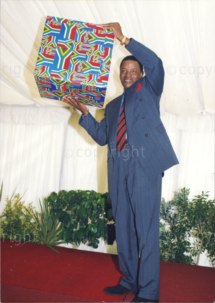 Cape Town, Western Cape, South Africa, 19970418. PHOTO: ANC Archives.

Kgosi Victor S. Suping from the North West Province holds a wrapped gift aloft at the inauguration of the National Council of Traditional Leaders in Cape Town, Western Cape, South Africa on 18 April 1997.