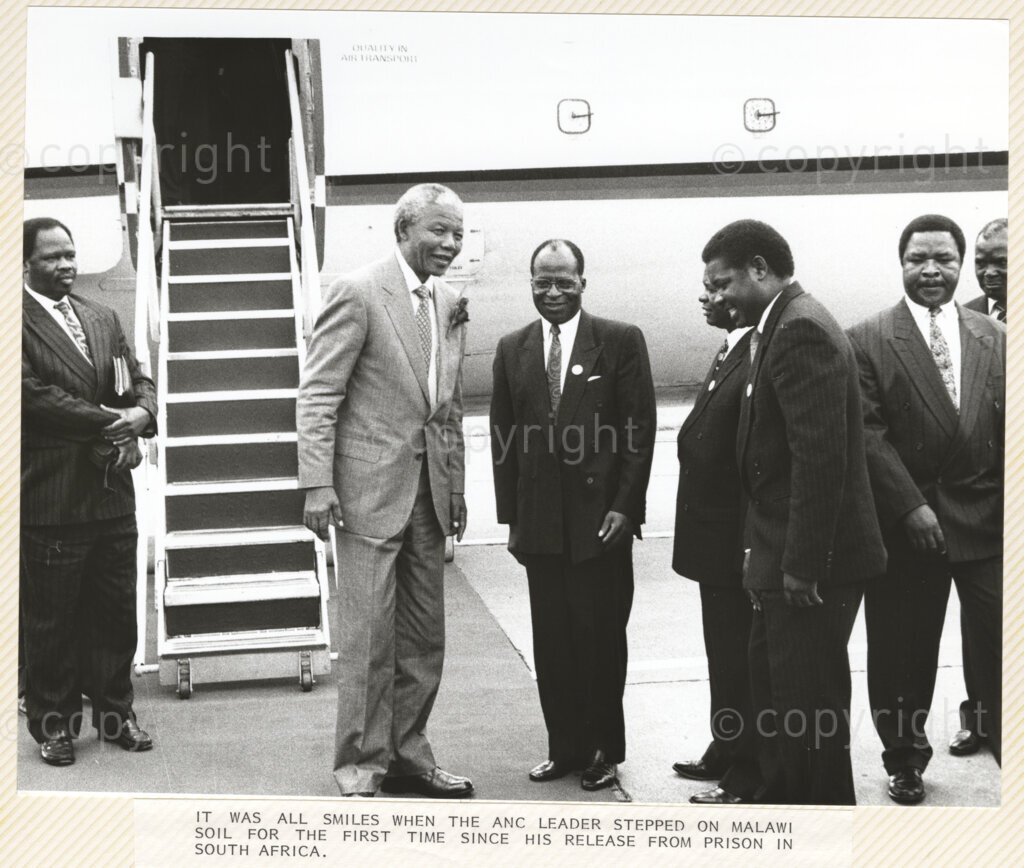 Chileka Airport, Blantyre, Blantyre District, Malawi, 19920617. PHOTO: ANC Archives.

The President of the African National Congress, Nelson Mandela (second left) is greeted by Malawian governmental dignitaries upon his arrival at Chileka Airport, Blantyre, Malawi on 17 June 1992.