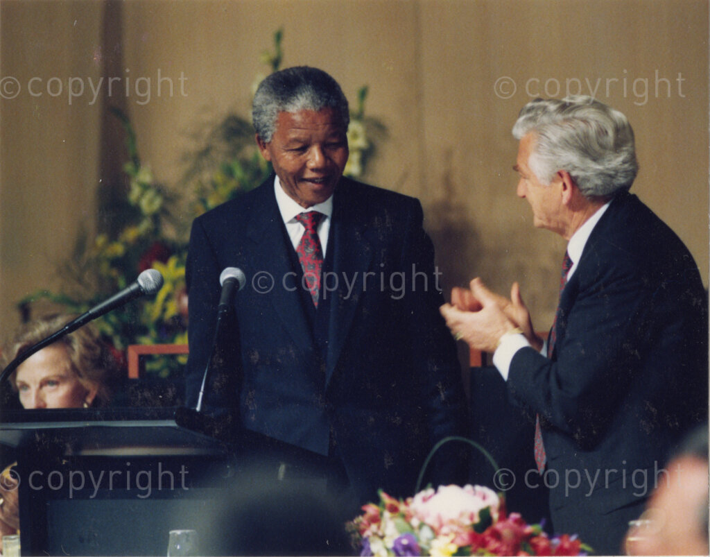 Australia, October 1990. PHOTO: ANC Archives: After his address, Nelson Mandela, Deputy President of the African National Congress, is applauded by Australian Prime Minister, Bob Hawke. When Mandela visits the country in 1990, although he is widely acclaimed for his human rights commitment, he angers those who are working to promote the rights of the Aborigines. He never refers to the plight of the Aborigines during his visit. Monday 22 October to Saturday 27 October 1990.
