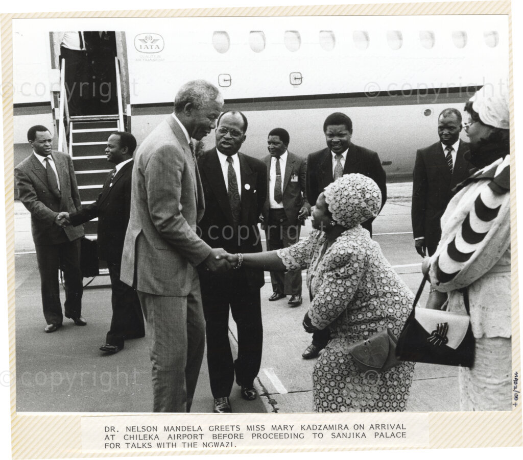 Chileka Airport , Blantyre, Blantyre District, Malawi, 19920617. PHOTO: ANC Archives.

Nelson Mandela (left) greets Mary Kadzamira (right) upon his arrival at Chileka airport, Blantyre Malawi on 17 June 1992 before proceeding to Sanjika Palace for talks with the President of the Republic of Malawi, Ngwazi Dr Hastings Kamuzu Banda.