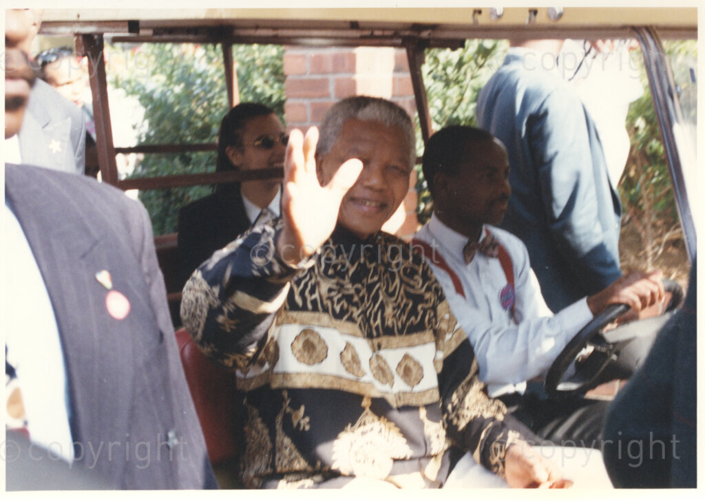 Gold Reef City, Johannesburg, Gauteng, South Africa, 19950717. PHOTO: ANC Archives.

The President of South Africa, Nelson Mandela, accompanied by his grandniece Rochelle Mtirara (in the back seat), waves to his guests from the yellow golf cart that is carrying him to his 77th birthday celebration at Gold Reef City, Johannesburg, on Monday the 17th July 1995. More than 2,000 underprivileged children, including 34 children who are currently imprisoned, street children, children from orphanages, mentally disabled children and children who have been abused, have been invited to attend his birthday celebration with him. nelson Mandela is attending this function in his personal capacity as he places special emphasis on the plight of children.