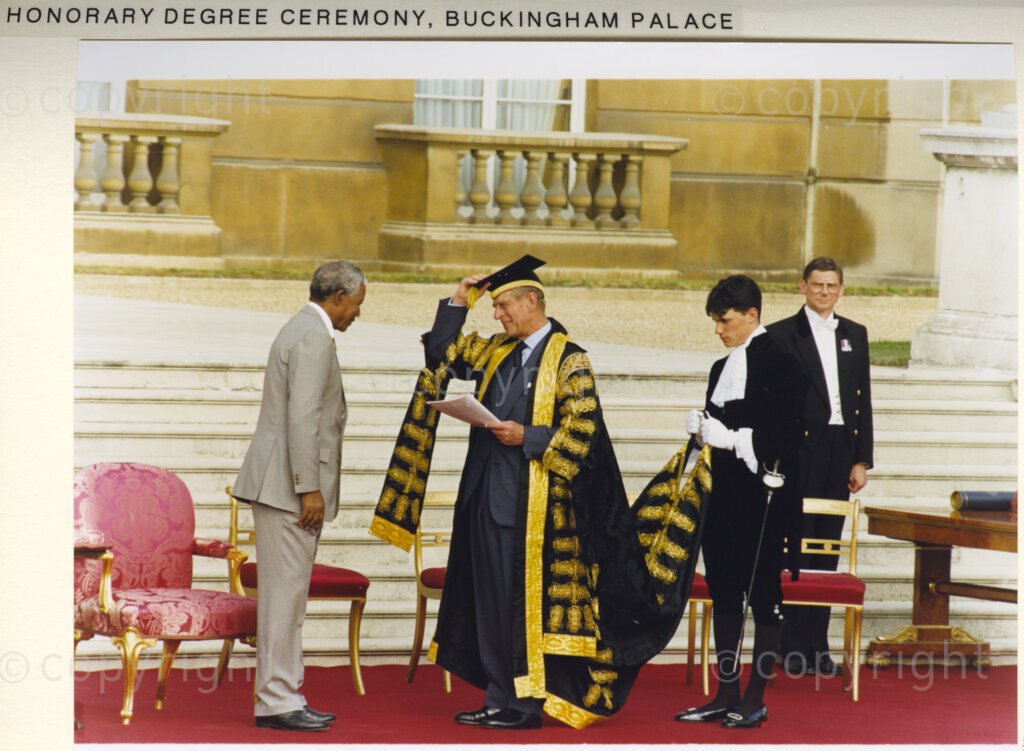 Buckingham Palace gardens, London, United Kingdom , 19960701. PHOTO: ANC Archives: President Nelson Mandela is on a state visit to the United Kingdom in July 1996. While he is there, he is awarded honorary degrees from eight United Kingdom universities, including Oxford and Cambridge. The award ceremony is held in Buckingham Palace gardens.