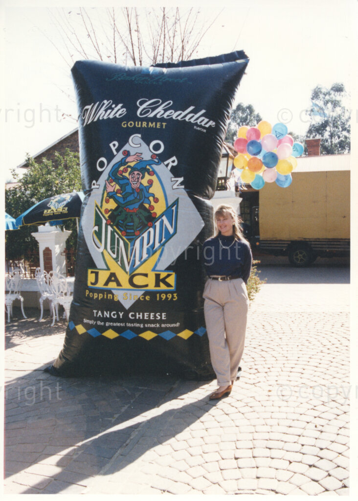 Gold Reef City, Johannesburg, Gauteng, South Africa, 19950717. PHOTO: ANC Archives.

A woman stands beside a giant inflatable balloon in the shape of a bag of popcorn, advertising one of the companies sponsoring the 77th birthday celebration of the President of South Africa, Nelson Mandela, at Gold Reef City, Johannesburg, on Monday the 17th July 1995. More than 2,000 underprivileged children, including 34 children who are currently imprisoned, street children, children from orphanages, mentally disabled children and children who have been abused, have been invited to attend his birthday celebration with him. Nelson Mandela is attending this function in his personal capacity as he places special emphasis on the plight of children. A variety of entertainments and food stalls are available for the children to enjoy.