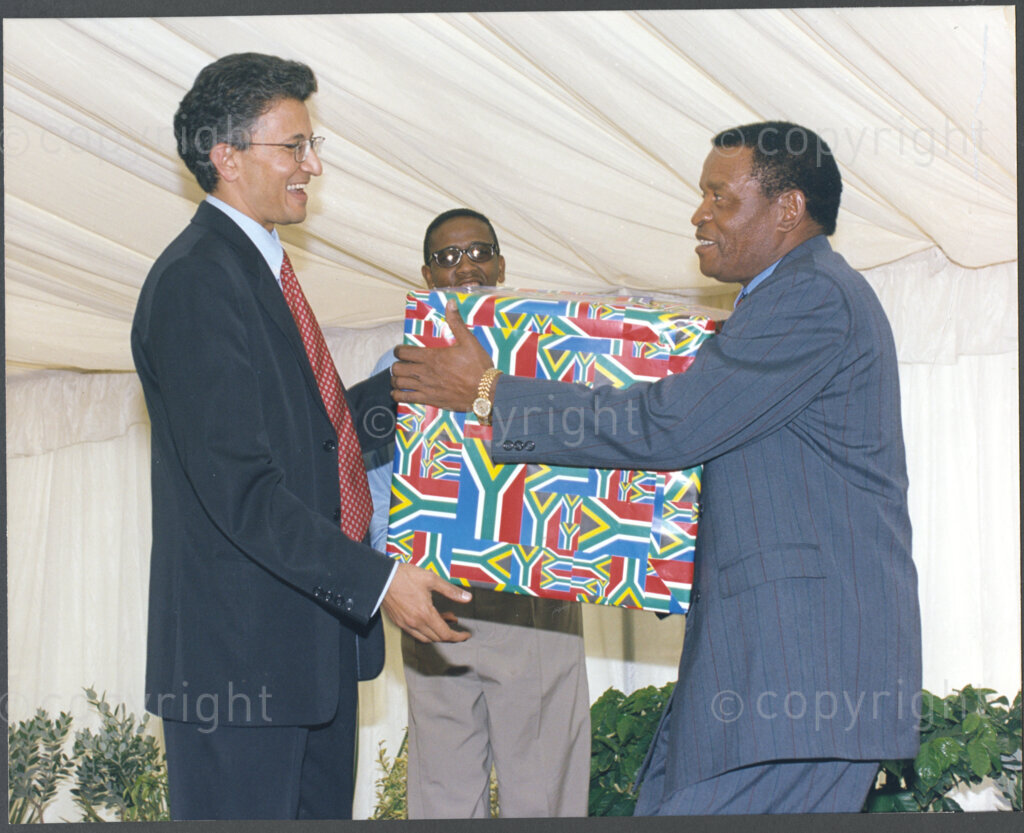 Cape Town, Western Cape, South Africa, 19970418. PHOTO: ANC Archives.

Kgosi Victor S. Suping (right) from the North West Province hands a gift to Ebrahim Patel (left) at the inauguration of the National Council of Traditional Leaders in Cape Town, Western Cape, South Africa on 18 April 1997.