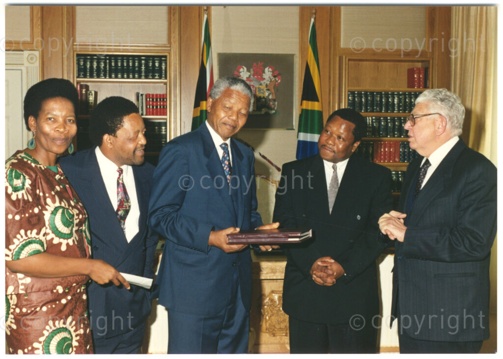 South Africa, 19940805. PHOTO: ANC Archives.

President Nelson Mandela of South Africa (centre) is awarded a memento and a cheque worth R50 000 by the chairman of the Press Corporation of South Africa (Perskor), JM (Koos) Buitendag (right). Three other unidentified officials are also present. The donation was made by the Bona People's Fund towards the Nelson Mandela Children's Fund on 5 August 1994.