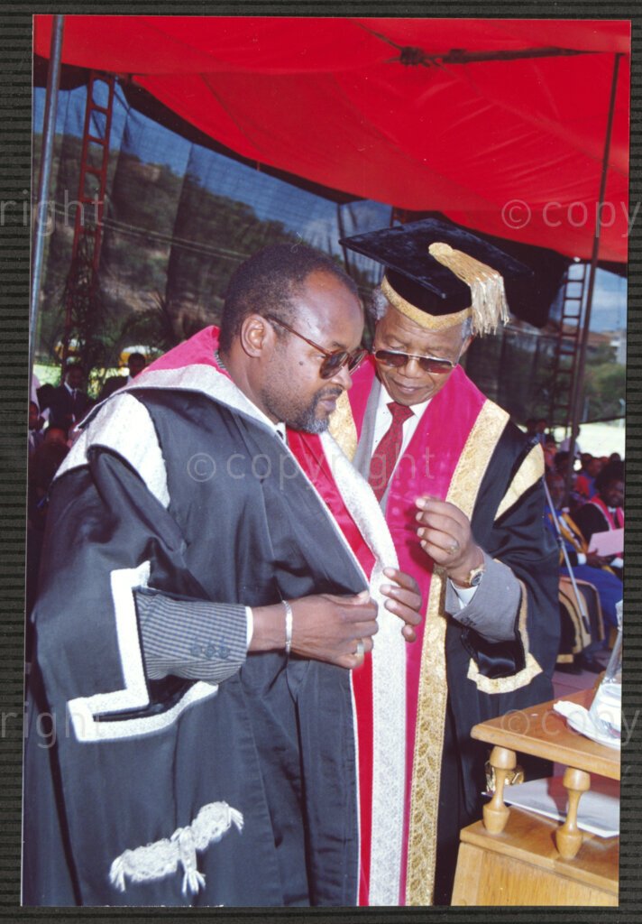 Turfloop Campus, University of the North, Mankweng, Northern Transvaal, South Africa, 19920425. PHOTO: ANC Archives.

Nelson Mandela, the president of the African National Congress (ANC) (right), assists Professor Noel Chabani Manganyi (left) with his toga during the ceremony that sees them installed as chancellor and vice chancellor of the University of the North respectively (now the University of Limpopo), 25 April 1992, Turfloop Campus, University of the North, Mankweng, Northern Transvaal (now Limpopo), South Africa.