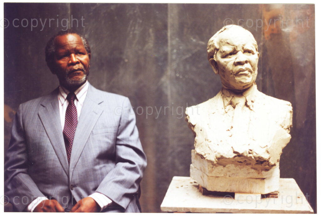 Haringey , London, England, United Kingdom, Date Unknown. PHOTO: ANC Archives.

Former African National Congress (ANC) President, Oliver Tambo posing for a bust of himself modelled from clay by sculptor Ian Walters.