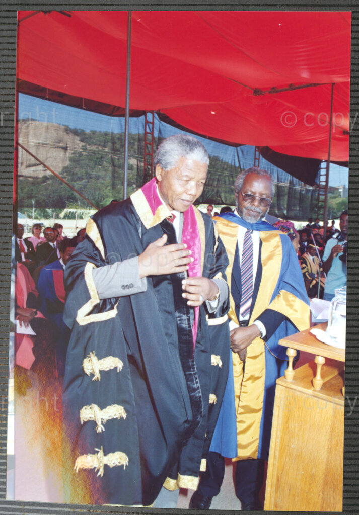 Turfloop Campus, University of the North, Mankweng, Northern Transvaal, South Africa, 19920425. PHOTO: ANC Archives.

Professor Walter Kamba, the chairman of the International Association of Universities and former vice chancellor of the University of Zimbabwe (right), stands beside Nelson Mandela, the president of the African National Congress (ANC) (left), during Mandela's installation as chancellor of the University of the North, 25 April 1992, Turfloop Campus of the University of the North (now the University of Limpopo), Mankweng, Northern Transvaal (now Limpopo), South Africa.