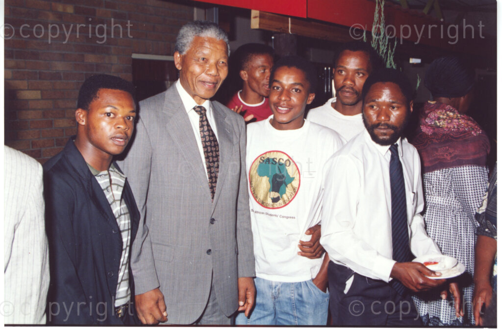 Turfloop Campus, University of the North, Mankweng, Northern Transvaal, South Africa, 19920424. PHOTO: ANC Archives.

Nelson Mandela, the president of the African National Congress (ANC) (second left), smiles broadly as he interacts with a group of guests at a celebratory function after the naming ceremony of the Oscar Mpetha Stadium and the student halls of residence at the Turfloop Campus of the University of the North (now the University of Limpopo), Mankweng, Northern Transvaal (now Limpopo), South Africa, 24 April 1992.