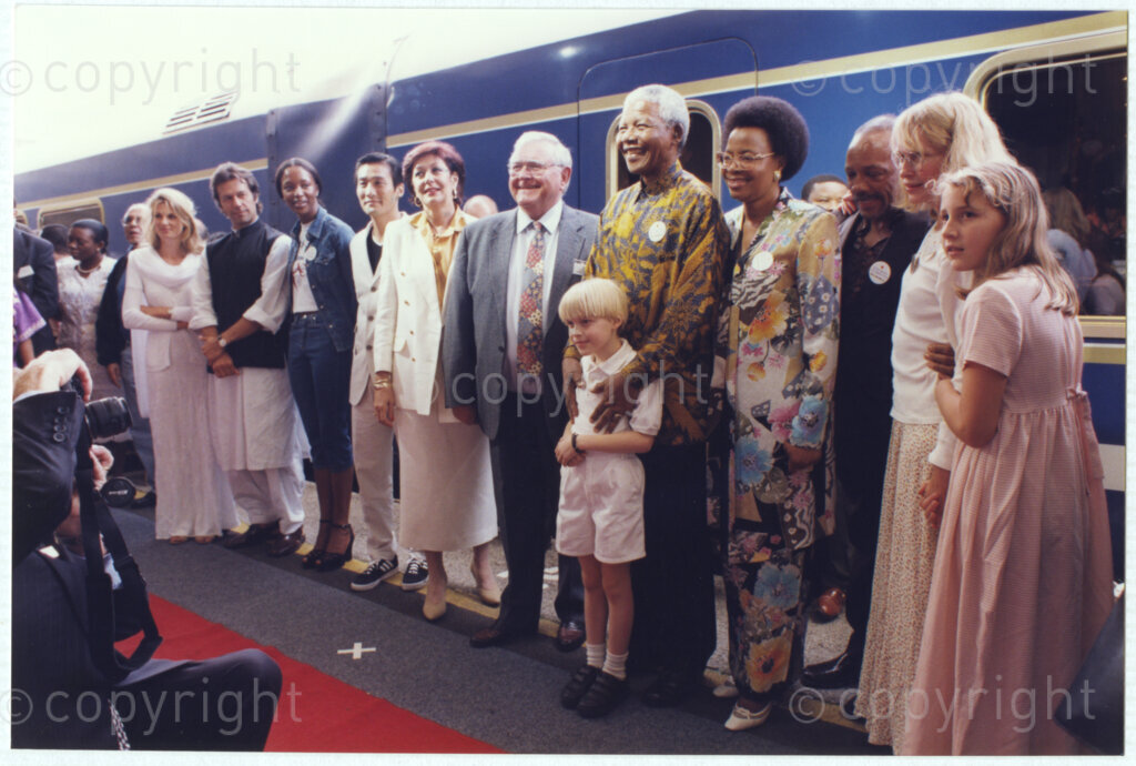 Cape Town Railway Station, Cape Town, Cape Province, Republic of South Africa, 19970927. PHOTO: ANC Archives.

A number of celebrities assemble with Nelson Mandela at the launch of the new Blue Train at Cape Town Railway Station on 27 September 1997. Photographed from left to right, Jemimah Khan, Imran Khan, Naomi Campbell, Tony Leung, Anna-Mari Kriel, Premier of the Western Cape, Hernus Kriel, President Nelson Mandela, with Mia Farrow's son, Seamus O' Sullivan-Farrow, Graca Machel, Quincy Jones, Mia Farrow and Malone O' Sullivan-Farrow.