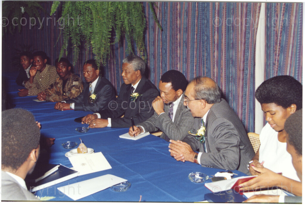 Turfloop Campus, University of the North, Mankweng, Northern Transvaal, South Africa, 19920425. PHOTO: ANC Archives.

Kader Asmal, a member of the council of the University of the North (second right), Nelson Mandela, the president of the African National Council (ANC), and other university members engaged in a meeting the day of Mandela's installation as chancellor of the University of the North (now the University of Limpopo), Turfloop Campus, Mankweng, Northern Transvaal (now Limpopo), South Africa, 25 April 1992.