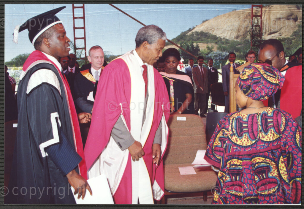 Turfloop Campus, University of the North, Mankweng, Northern Transvaal, South Africa, 19920425. PHOTO: ANC Archives.

John Malatji, the deputy vice chancellor the University of the North (left), Nelson Mandela, the president of the African National Congress (ANC) (centre), and Professor Noel Chabani Manganyi (right), all dressed in full academic regalia, are shown to their seats at the ceremony that sees Mandela and Manganyi installed as chancellor and vice chancellor of the University of the North respectively, 25 April 1992, Turfloop Campus, University of the North (now the University of Limpopo), Mankweng, Northern Transvaal (now Limpopo), South Africa.