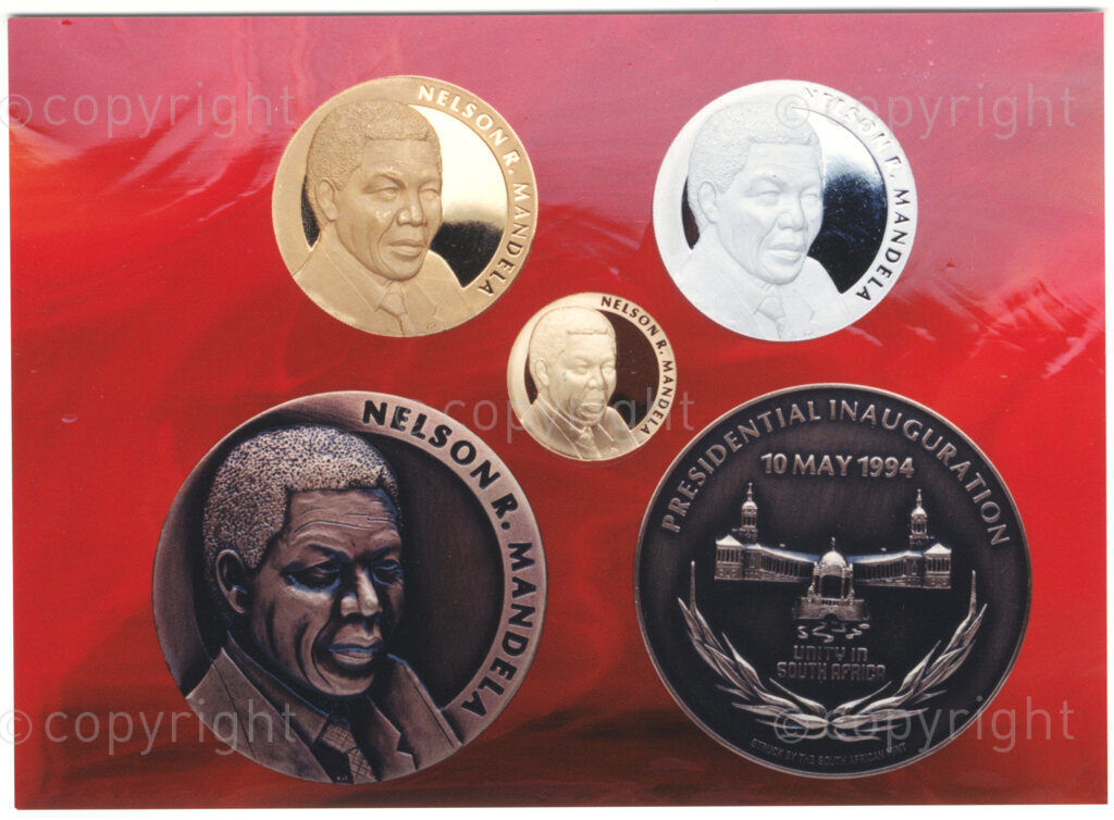 South African Mint, Johannesburg, Gauteng, South Africa, 19950919. PHOTO: ANC Archives.

A Nelson R. Mandela Presidential Medallion collection that has been minted by the South African Mint in 1995, to commemorate the inauguration of the country's first democratically elected president in 1994. The collection has been commissioned by Education Africa; the proceeds from the sale of medallions in the collection are going towards the funding of education projects in South Africa. The designers of the collection are Arthur Sutherland (Obverse) and Susan Erasmus (Reverse). The collection consists of a 5-ounce gold medallion (top left); a 1-ounce gold medallion (centre); a 5-ounce silver medallion (top right) and a 75 mm bronze medallion (bottom).