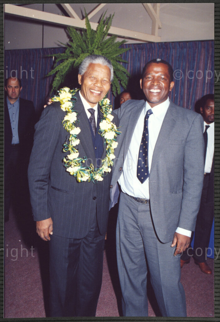 Turfloop Campus, University of the North, Mankweng, Northern Transvaal, South Africa, 19920425. PHOTO: ANC Archives.

Nelson Mandela, the president of the African National Congress (ANC) (left), in a celebratory mood and wearing a lei of flowers around his neck, stands with an unidentified man at a celebratory function on the day of his installation as chancellor of the University of the North (now the University of Limpopo), 25 April 1992, Turfloop Campus, Mankweng, Northern Transvaal (now Limpopo), South Africa.
