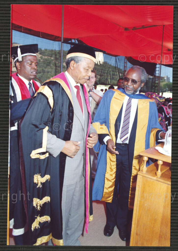 Turfloop Campus, University of the North, Mankweng, Northern Transvaal, South Africa, 19920425. PHOTO: ANC Archives.

Professor Walter Kamba, the chairman of the International Association of Universities and former vice chancellor of the University of Zimbabwe (right), stands at the podium beside Nelson Mandela, the president of the African National Congress (ANC) (centre), during Mandela's installation as chancellor of the University of the North, 25 April 1992, Turfloop Campus of the University of the North (now the University of Limpopo) , Mankweng, Northern Transvaal (now Limpopo), South Africa. Deputy Vice Chancellor John Malatji looks on (behind Mandela).