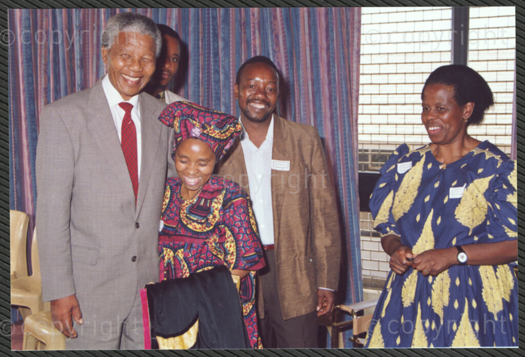 Turfloop Campus, University of the North, Mankweng, Northern Transvaal, South Africa, 19920425. PHOTO: ANC Archives.

Nelson Mandela, the president of the African National Congress (ANC) (left), smiles broadly as he stands with a group of unidentified men and women at a celebratory function on the occasion of his installation as chancellor of the University of the North (now the University of Limpopo), 25 April 1992, Turfloop Campus, University of the North, Mankweng, Northern Transvaal (now Limpopo), South Africa.