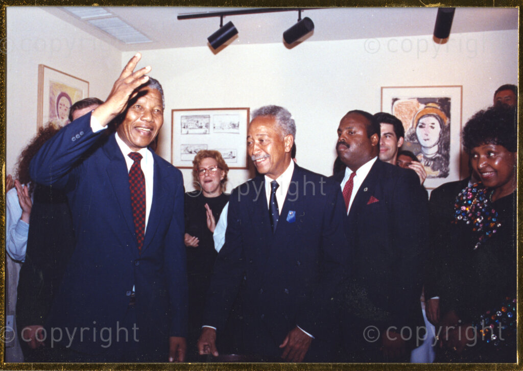 New York, New York State, United States of America, 19900601. PHOTO: ANC Archives.

In 1990, Nelson Mandela and his wife, Winnie Mandela, visit the city of New York in the United States of America, from 20 to 23 June. This is the start of a 14 nations Freedom Tour, just 4 months after Mandela's release from jail. He is seen here on the left, waving to the crowd. Beside him is his host, Mayor David Dinkins. Winnie stands on the extreme right of the image. The welcome Mandela receives from tens of thousands of people during his stay in New York, is rapturous.