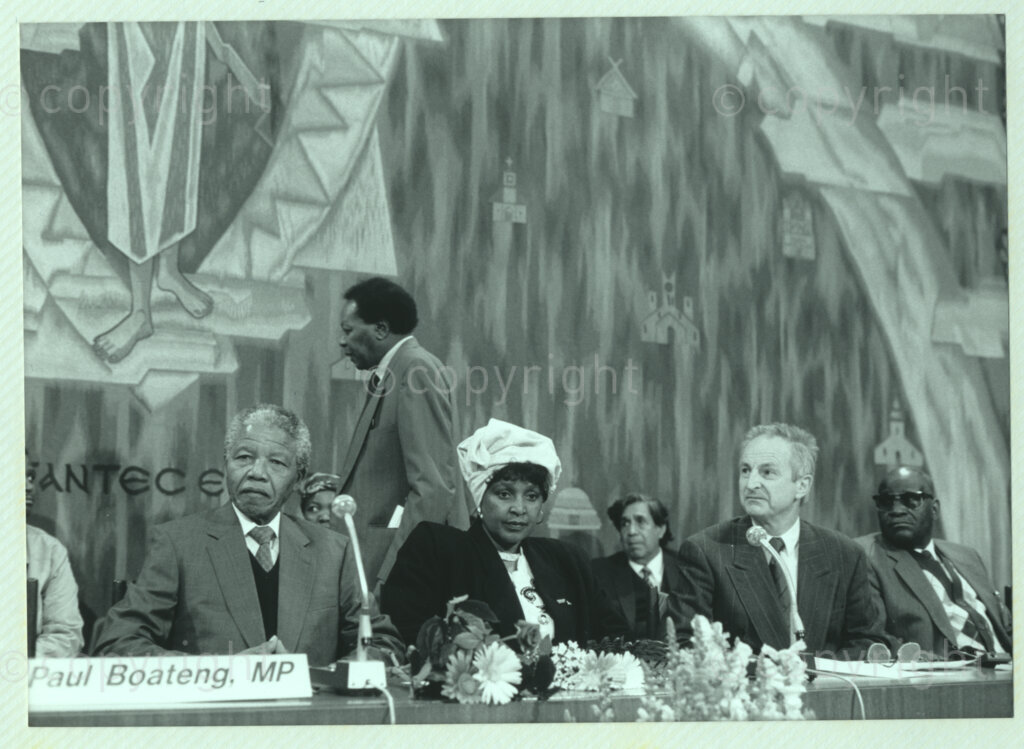 Geneva Ecumenical Centre, Geneva, Switzerland, 19900601. PHOTO: ANC Archives.

Seated at the main table on stage (left to right) recently elected Deputy President of the African National Congress (ANC) Nelson Mandela, Winnie Madikizela-Mandela and unidentified officials at the Geneva Ecumenical Centre, Switzerland when the Mandela couple visit staff, officials and representatives of the World Council of Churches (WCC) during Nelson Mandela's official visit to Switzerland, 4-9 June 1990. During the visit, barely a few months after his release from prison, Nelson Mandela expresses his gratitude to the church for its support of the anti-apartheid struggle.