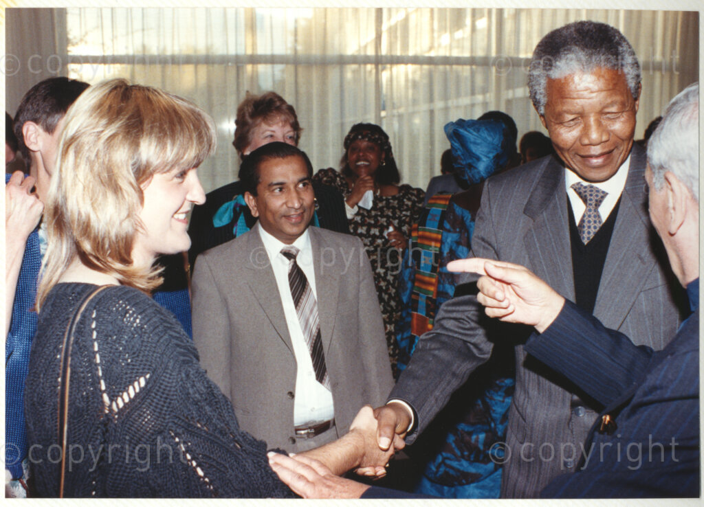 World Council of Churches, Geneva, Switzerland, 19900601. PHOTO: ANC Archives.

A group photograph of recently elected Deputy President of the African National Congress (ANC) greeting Sabine Udodeskhu (left) Ghanaian administrative assistant for the World Council of Churches (WCC) during Nelson Mandela's official visit to Switzerland, 4-9 June 1990. During the visit, a few months after his release from prison, Nelson Mandela expresses his gratitude to the church for its support of the anti-apartheid struggle.