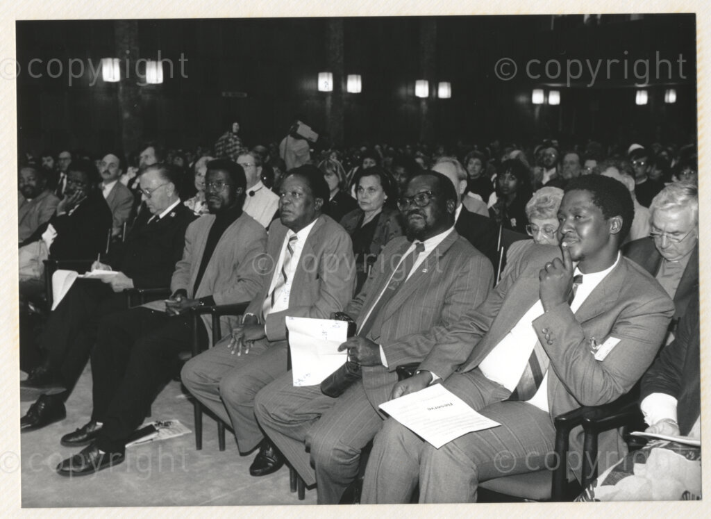 Geneva Ecumenical Centre, Geneva, Switzerland, 19900601. PHOTO: ANC Archives.

Director of the World Council of Churches' (WCC) Programme to Combat Racism Nyameko Barney Pityana (right), General Secretary of the All Africa Conference of Churches Reverend Canon Clement Janda (second right) and author James Chamunorwa Mutambirwa (third right) seated in the auditorium at the Geneva Ecumenical Centre, Switzerland when the Mandela couple visit staff, officials and representatives of the World Council of Churches (WCC) during Nelson Mandela's official visit to Switzerland, 4-9 June 1990. During the visit, barely a few months after his release from prison