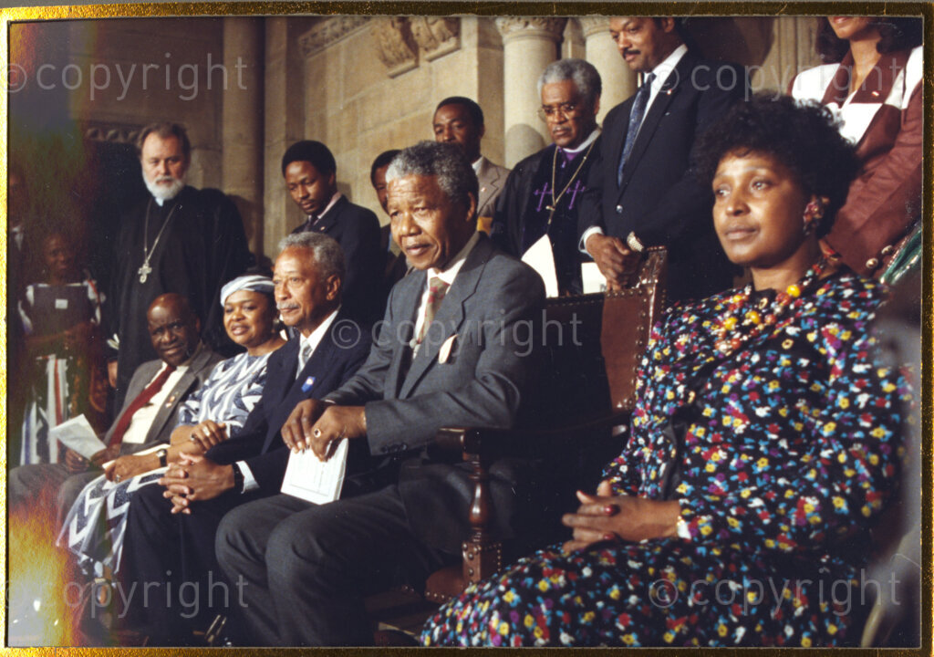 New York, New York State, United States of America, 19900621. PHOTO: ANC Archives.

In 1990, Nelson Mandela and his wife, Winnie Mandela, visit the city of New York from 20 to 23 June. This is the start of a 14-nations Freedom Tour, just 4 months after Mandela's release from jail. From right to left, Winnie, Nelson and their host, New York Mayor David Dinkins, all seated and awaiting Mandela's address. The welcome he receives from thousands of people is rapturous.