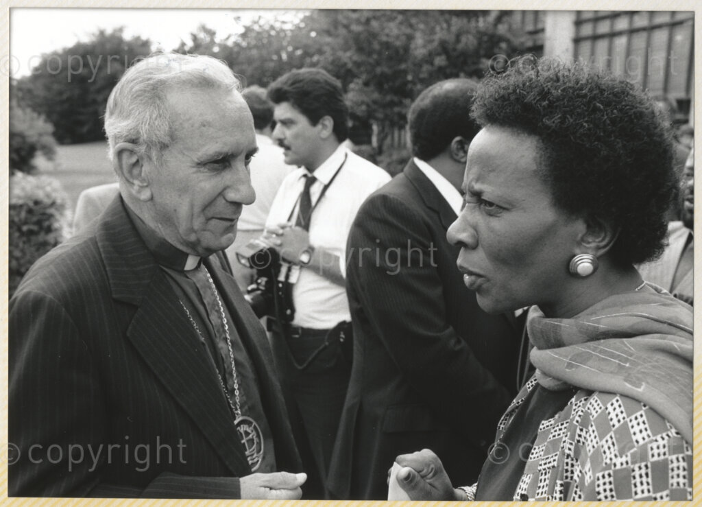 Geneva Ecumenical Centre, Geneva, Switzerland, 19900601. PHOTO: ANC Archives.

A few months after his release from prison, newly elected Deputy President of the African National Congress (ANC) Nelson Mandela and his wife, Winnie Madikizela-Mandela make an official visit to Switzerland, 4-9 June 1990. Shortly after his arrival in Geneva, he visits the staff and officials and representatives of the World Council of Churches (WCC) at the Geneva Ecumenical Centre. Standing in the gardens of the Centre amongst the media, Deputy General Secretary of the South African Council of Churches (SACC) Brigalia Bam speaks to General Secretary of the WCC Emilio Castro.