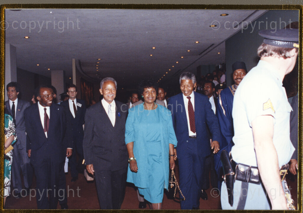 New York, New York State, United States of America, 19900601. PHOTO: ANC Archives.

In 1990, Nelson Mandela and his wife, Winnie Mandela, visit the city of New York from 20 to 23 June. This is the start of a 14-nations Freedom Tour, just 4 months after Mandela's release from jail. The Mandela couple are seen here being escorted into a venue by New York Mayor David Dinkins, who is walking on the right side of Winnie.