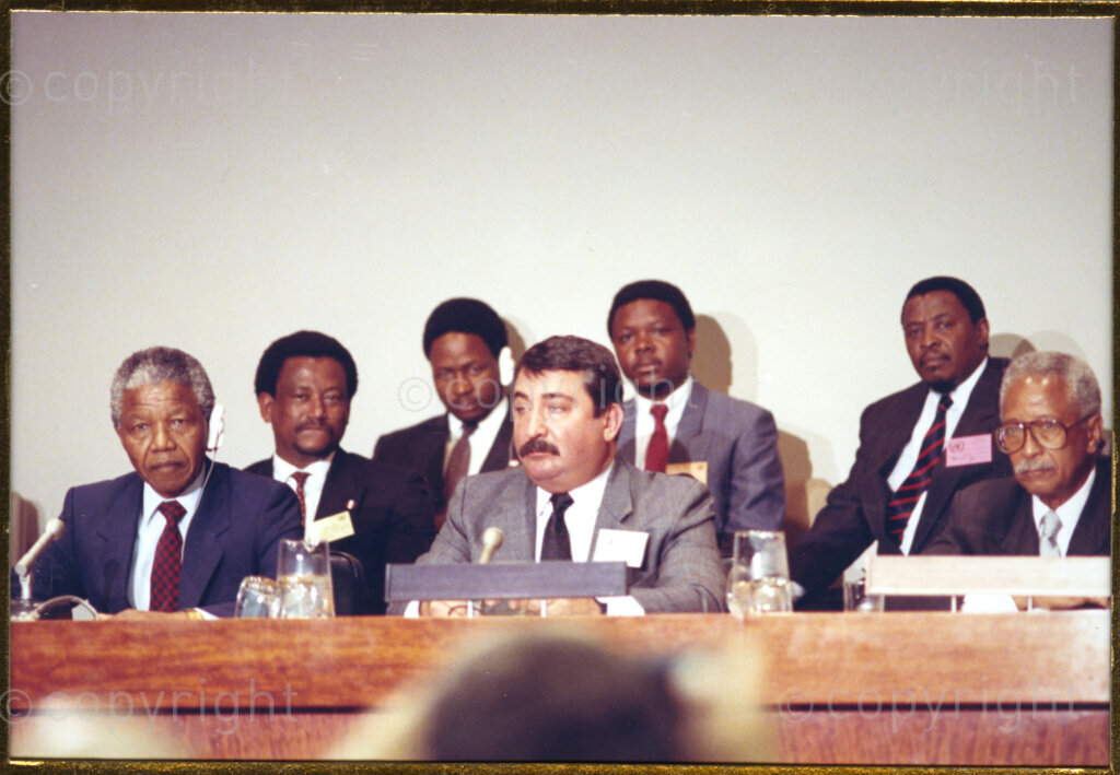 Manhattan, New York, New York State, United States of America, 19900601. PHOTO: ANC Archives.

In 1990, Nelson Mandela and his wife, Winnie Mandela, visit the city of New York from 20 to 23 June. This is the start of a 14-nations Freedom Tour, just 4 months after Mandela's release from jail. Dignitaries and business leaders meet in Manhattan to discuss economic pressure on the apartheid government of South Africa. Mandela is seated on the left and unidentified executives are seated behind him and on his left.