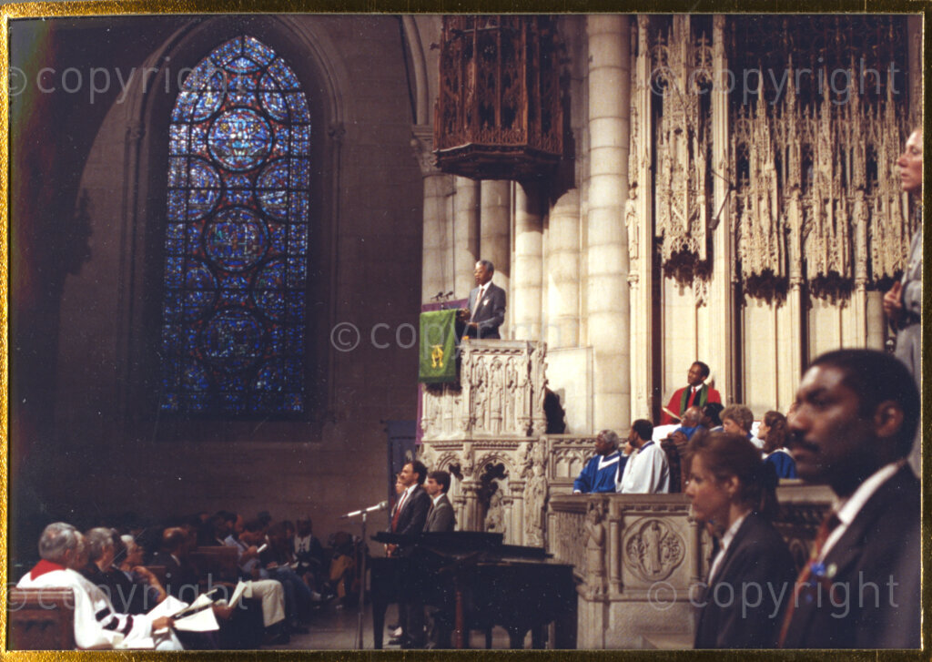 Trinity Church, New York, New York State, United States of America, 19900620. PHOTO: ANC Archives.

In 1990, Nelson Mandela and his wife, Winnie Mandela, visit the city of New York from 20 to 23 June. This is the start of a 14-nations Freedom Tour, just 4 months after Mandela's release from jail. His first public address is from the pulpit of the Trinity Church in New York, where he is seen on the left of this image. The welcome he receives from the congregation is rapturous.