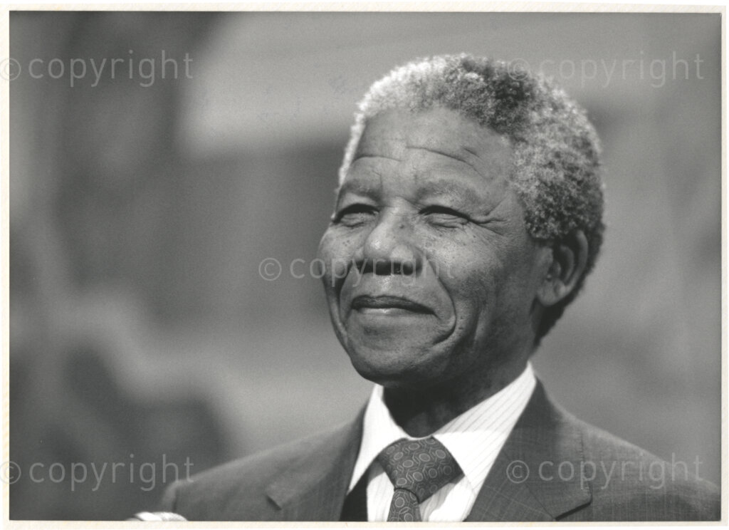 Geneva Ecumenical Centre, Geneva, Switzerland, 19900601. PHOTO: ANC Archives.

A photographic portrait of newly appointed Deputy President of the African National Congress (ANC) Nelson Mandela at the Geneva Ecumenical Centre, Switzerland barely a few months after his release from prison, when he and his wife, Winnie Madikizela-Mandela pay an official visit to Switzerland, 4-9 June 1990. Shortly after his arrival in Geneva, he visits the staff and officials and representatives of the World Council of Churches (WCC) at the Ecumenical Centre.