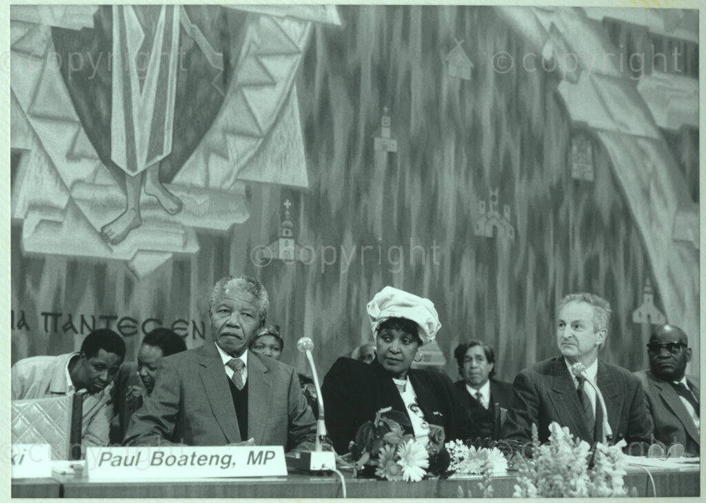 Geneva Ecumenical Centre, Geneva, Switzerland, 19900601. PHOTO: ANC Archives.

Seated at the main table on stage (left to right) recently elected Deputy President of the African National Congress (ANC) Nelson Mandela, Winnie Madikizela-Mandela and unidentified officials at the Geneva Ecumenical Centre, Switzerland when the Mandela couple visit staff, officials and representatives of the World Council of Churches (WCC) during Nelson Mandela's official visit to Switzerland, 4-9 June 1990. During the visit, barely a few months after his release from prison, Nelson Mandela expresses his gratitude to the church for its support of the anti-apartheid struggle.