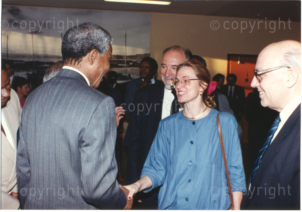 Geneva Ecumenical Centre , Geneva, Switzerland, 19900601. PHOTO: ANC Archives.

Recently elected Deputy President of the African National Congress (ANC) Nelson Mandela with his back to the camera greets economist, researcher and sociologist Midge Beguin-Austin (centre) and author Jean Pierre Jornod (right) when the Mandela couple visit staff, officials and representatives of the World Council of Churches (WCC) during Nelson Mandela's official visit to Switzerland, 4-9 June 1990. During the visit, barely a few months after his release from prison, Nelson Mandela expresses his gratitude to the church for its support of the anti-apartheid struggle.