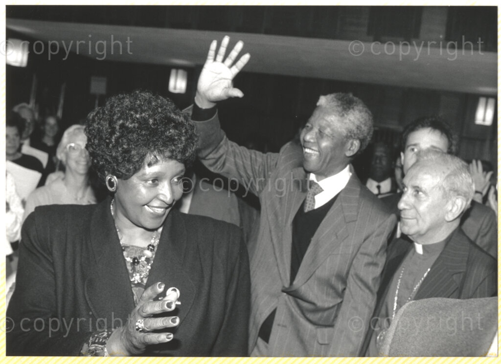 Geneva Ecumenical Centre, Geneva, Switzerland, 19900601. PHOTO: ANC Archives.

Waving graciously at bystanders, newly elected deputy president of the African National Congress (ANC) Nelson Mandela (centre) and his wife Winnie Madikizela-Mandela and General Secretary of the World Council of Churches (WCC) Emilio Castro at the Geneva Ecumenical Centre, Switzerland during the recently appointed Deputy President of the African National Congress (ANC) Nelson Mandela's official visit to Switzerland, 4-9 June 1990.