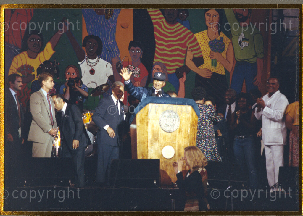 Yankee Stadium, New York, New York State, United States of America, 19900622. PHOTO: ANC Archives.

In 1990, Nelson Mandela and his wife, Winnie Mandela, visit the city of New York from 20 to 23 June. This is the start of a 14-nations Freedom Tour, just 4 months after Mandela's release from jail. Mandela is presented with a Yankees jacket and cap which he wears to the rally at the Yankee Stadium, where he gives an address. The welcome he receives from tens of thousands of people is rapturous.