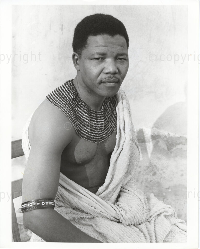 Date and Location Unknown PHOTO: ANC Archives:
Nelson Mandela in traditional dress. Nelson Mandela was a lawyer, anti-apartheid activist, banned person, ANC member, SACP member, MK Commander in Chief, 1956 Treason Trialist, Robben Island prisoner, Nobel Peace Prize winner and first elected President of a democratic South Africa.