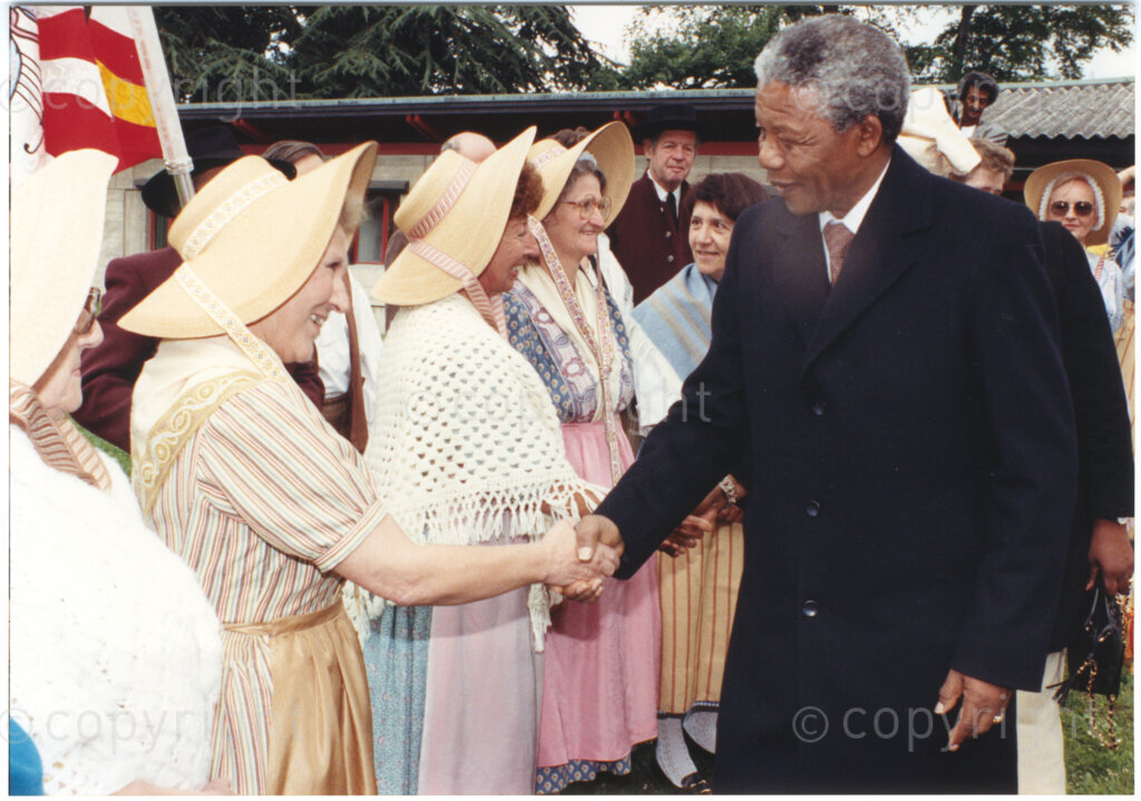 International Reformed Centre John Knox, Geneva, Switzerland, 19900609. PHOTO: ANC Archives.

Standing amongst a crowd of guests, recently appointed Deputy President of the African National Congress (ANC) Nelson Mandela greets a group of unidentified women wearing hats in the garden of the International Reformed Centre John Knox (IRCJK), Geneva, Switzerland, 9 June 1990 during Nelson Mandela's official visit to Switzerland, 4-9 June 1990.
