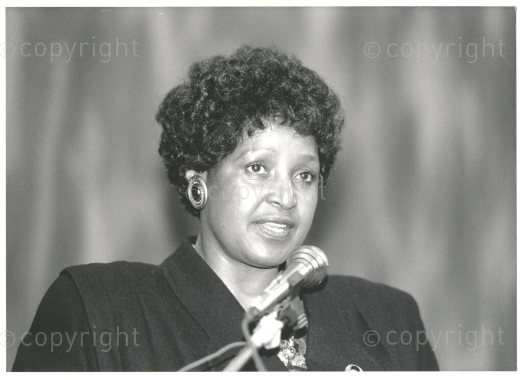 Geneva Ecumenical Centre, Geneva, Switzerland, 19900601. PHOTO: ANC Archives.

A photographic portrait of Winnie Madikizela-Mandela at the Ecumenical Centre in Geneva, a few months after newly elected Deputy President of the African National Congress (ANC) Nelson Mandela is released from prison and the couple visit staff, officials and representatives of the World Council of Churches, 4-9 June 1990, Geneva, Switzerland. During the visit, Nelson Mandela expresses his gratitude to the church for its support of the anti-apartheid struggle.