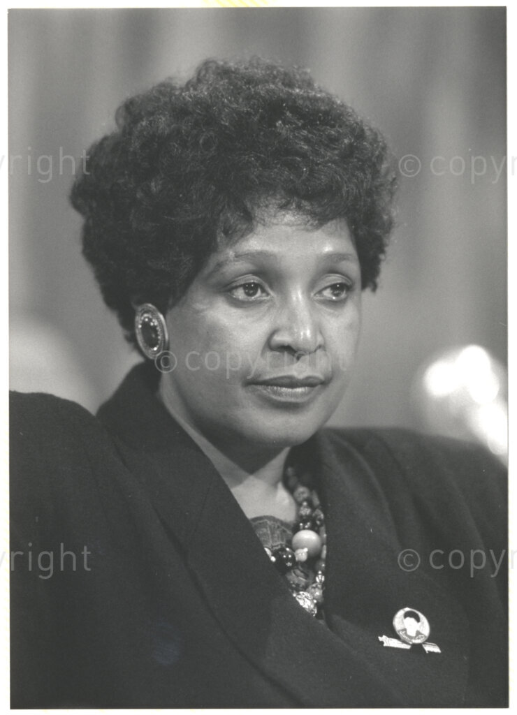 Geneva Ecumenical Centre, Geneva, Switzerland, 19900601. PHOTO: ANC Archives.

A photographic portrait of Winnie Madikizela-Mandela addressing a meeting at the Ecumenical Centre in Geneva, a few months after newly elected Deputy President of the African National Congress (ANC) Nelson Mandela is released from prison and the couple visit staff, officials and representatives of the World Council of Churches, 4-9 June 1990, Geneva, Switzerland. During the visit, Nelson Mandela expresses his gratitude to the church for its support of the anti-apartheid struggle.